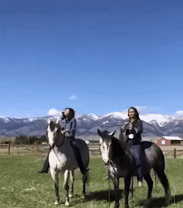 Trying to pop the champagne while on horse back