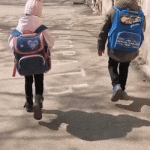 Children walking with backpack