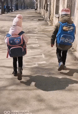 Children walking with backpack