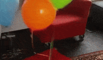 Baby playing with balloons